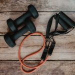 Resistance Bands - orange and black usb cable on brown wooden surface