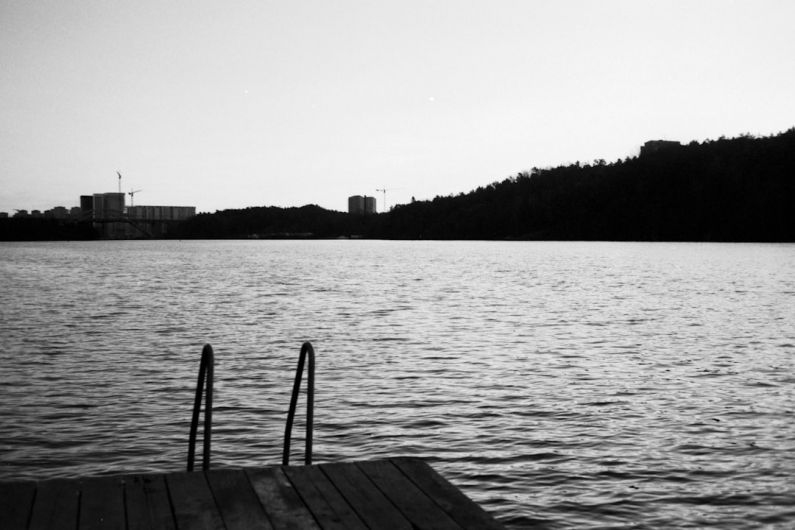 Outdoor Swimming - grayscale photo of wooden dock on body of water