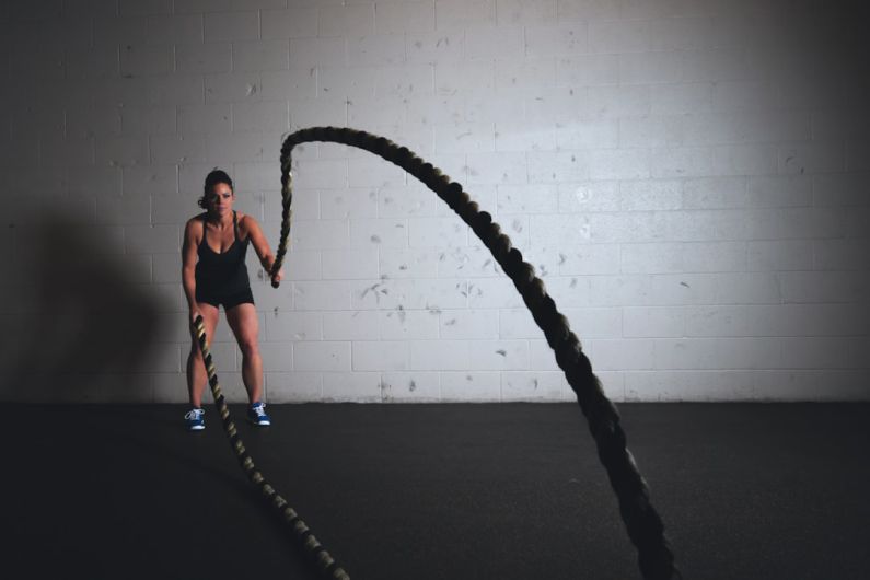 Innovative Gym Equipment - woman holding brown ropes