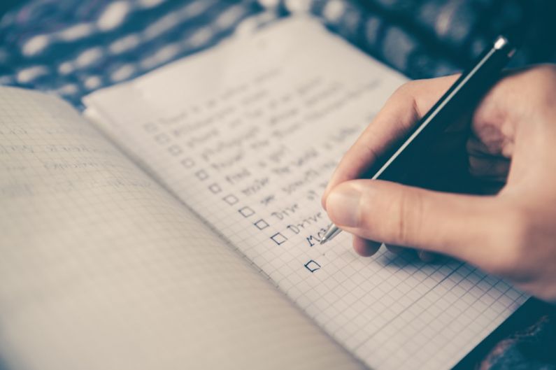 Workout Plan - person writing bucket list on book