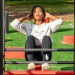 Cardio Strength - woman in white long sleeve shirt and black pants sitting on red metal frame