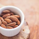 Muscle Recovery Food - shallow focus photography of almonds in white ceramic bowl