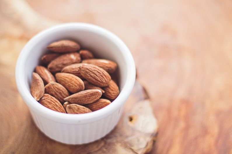 Muscle Recovery Food - shallow focus photography of almonds in white ceramic bowl