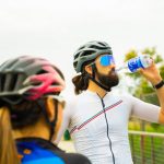 Hydration Fitness - a man with a beard drinking water from a bottle