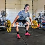 Strength Cardio - man carrying yellow barbell