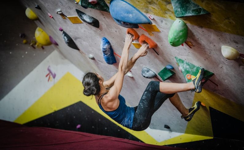 Strength Equipment - woman rock climbing inside building