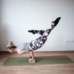 Yoga Flexibility - woman balancing her body on olive-green mat