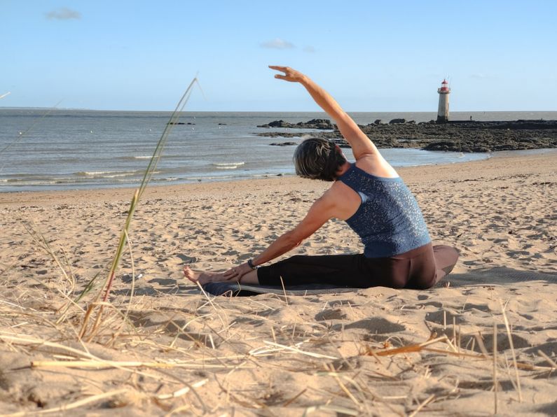 Advanced Pilates - a person sitting on a beach